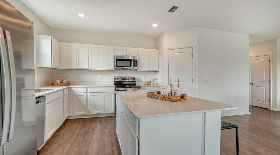 Large Kitchen With Quartz Countertops And Walk-In Pantry Photo For Example Only