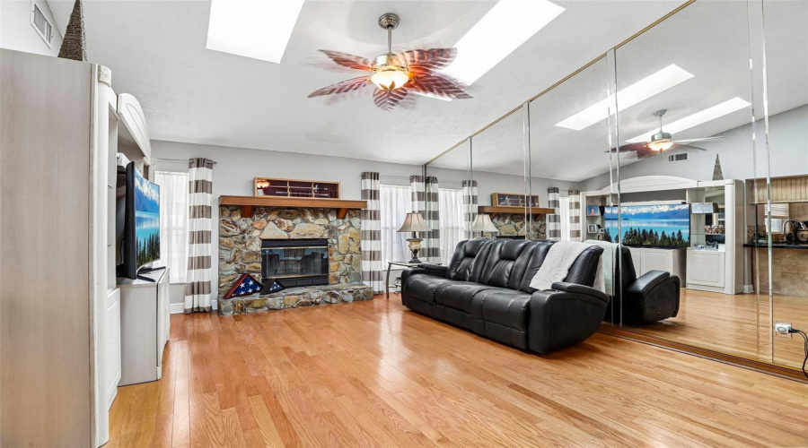 Family Room With Sky Lights And Wood Burning Fireplace