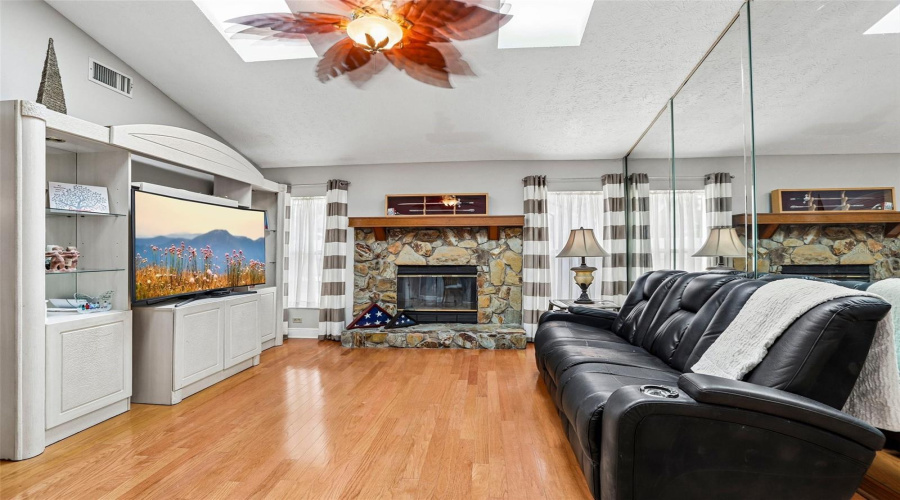 Family Room With Sky Lights And Wood Burning Fireplace