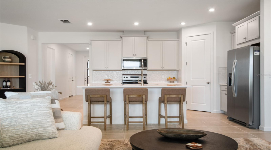 Refreshing White Cabinets Topped With Crown Molding, Dedicated Refrigerator Built In Topped With Storage Cabinets Area Just A Few Of These Upgraded Features In The Kitchen Area.