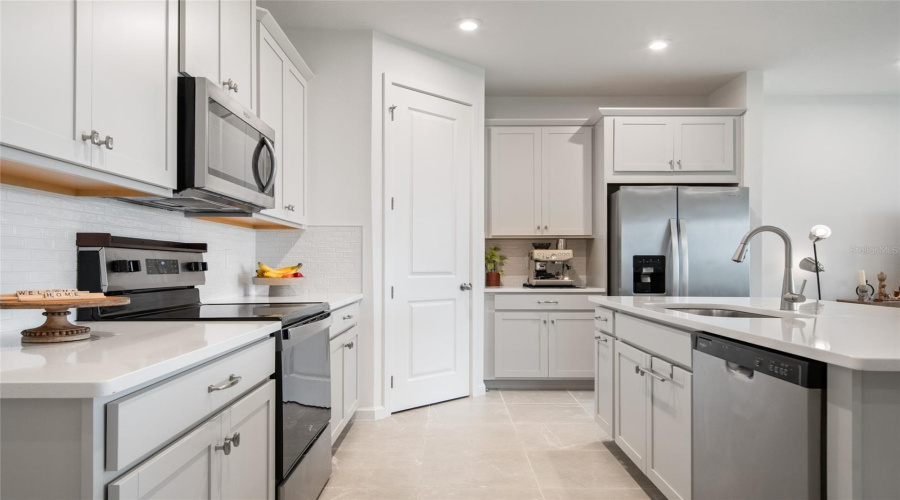Transitional Tile Back Splash, Stainless Steel Appliances Only 18 Months Old And Plenty Of Prep Space On The Counters Made Of Quartz.