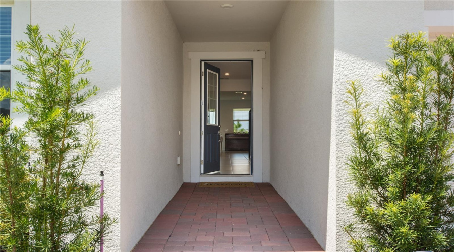 Upon Entering You Are Greeted With A Papered Walkway Leading To Your Cozy Front Door.