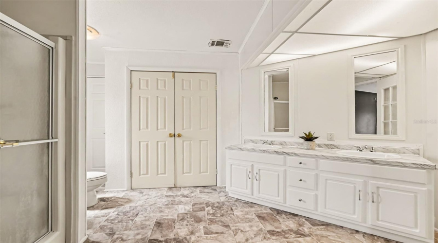 Primary Bathroom With New Vinyl Floors And New Vanity.