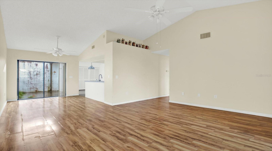 The Living Room Opens Directly To The Kitchen, With A Sliding Glass Door Out To The Lanai.