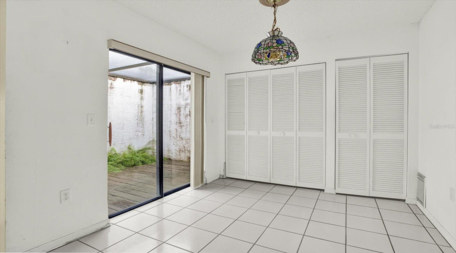 The Dining Nook, With A Sliding Glass Door To The Lanai And Laundry Closet.