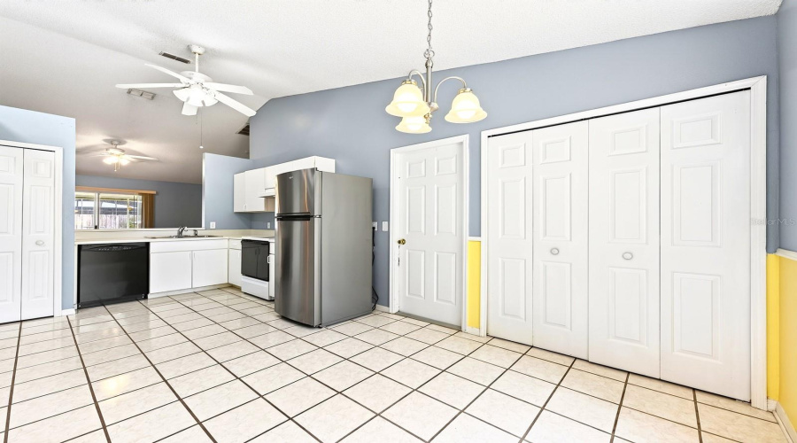 The Kitchen Offers Crisp White Cabinetry, A Closet Pantry And A Spacious Dining Area Filled With Natural Light.