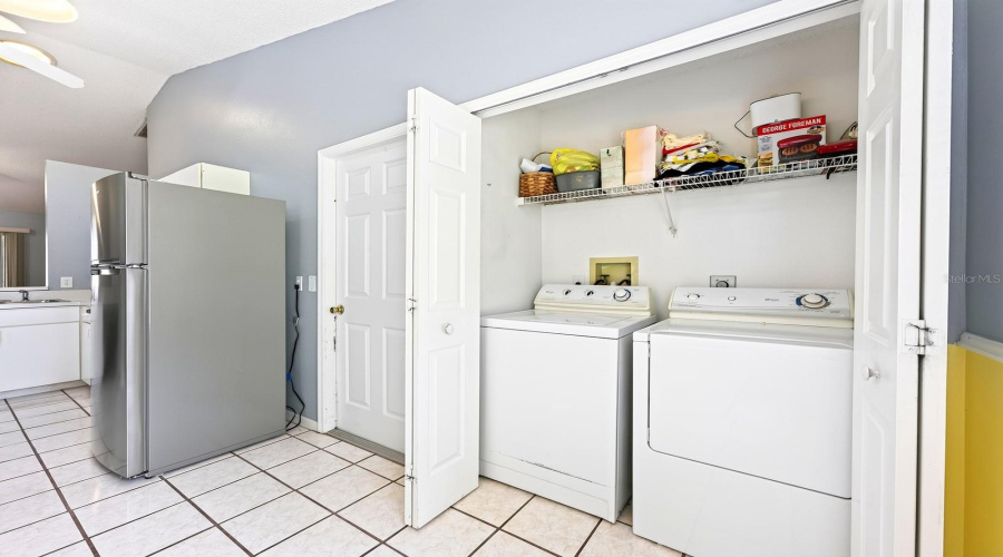 A Convenient Laundry Closet Is Tucked Into The Kitchen And Includes The Washer &Amp; Dryer And Shelving For Storing Supplies.