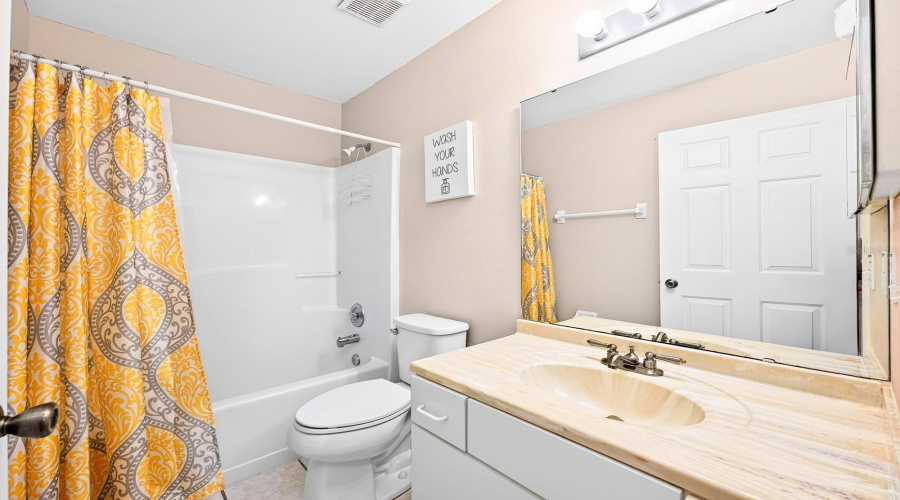 Two More Bedrooms Are Located On The Opposite Side Of The Home And Share A Second Full Bath, Perfect For Family Or Guests.