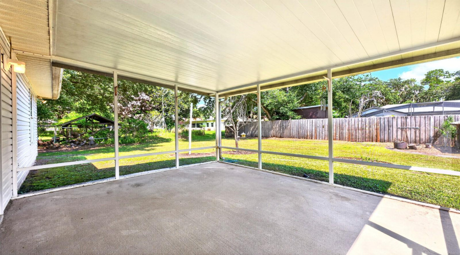 Outside, The Covered And Screened Porch Provides A Comfortable Spot To Enjoy The Generous Backyard.