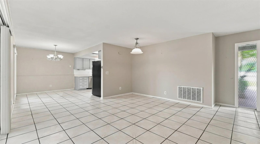 Tile Flooring, Built-In Display Cabinetry, Pendant Lighting, And A Chandelier Fixture
