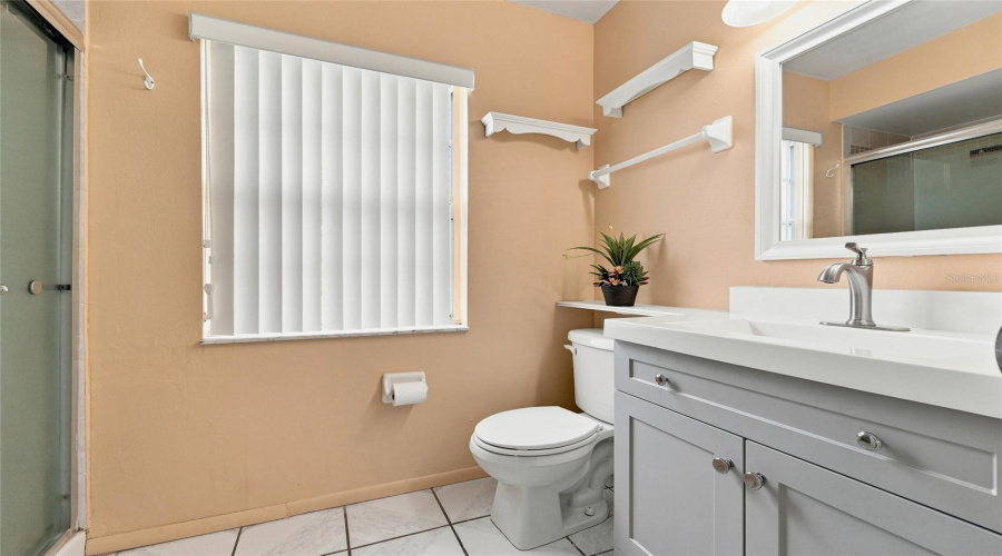 Vanity With Integrated Sink, Brushed Nickel Faucet, And Gray Cabinetry