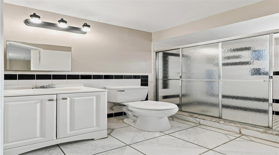 White Vanity With Integrated Sink, Chrome Faucet, And Panel-Front Cabinetry