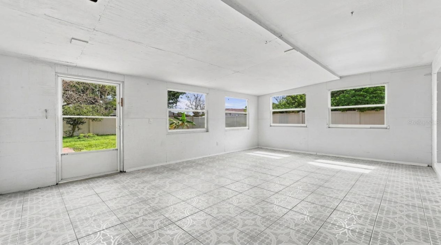 Patterned Tile Flooring, Multiple Windows, And A Glass-Paneled Door