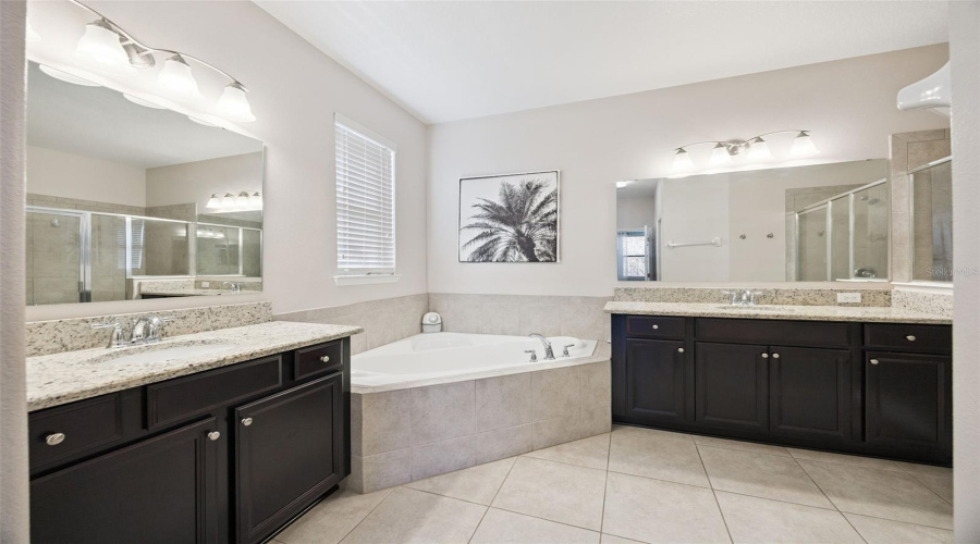 Primary Bathroom Features Dual Vanities And A Garden Tub