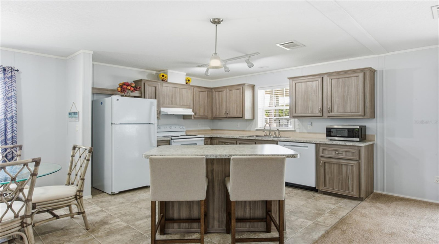 Kitchen With Bar Top Island And Dining Room