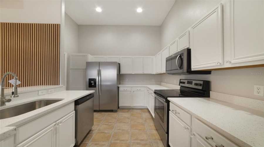 The Updated Kitchen Is Truly The Heart Of The Home, Featuring Abundant White Solid-Wood Cabinetry, Solid-Surface Countertops, Stainless Steel Appliances And A Convenient Breakfast Bar For Casual Meals Or Entertaining.