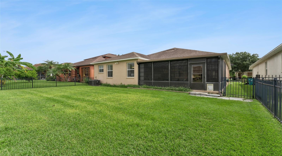 Enclosed Lanai Overlooks A Spacious Fenced Yard.