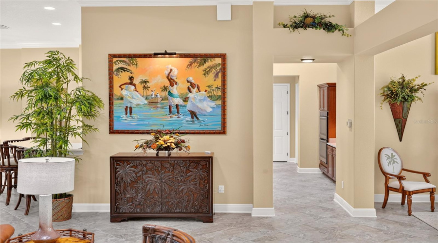 Another View Of The Spacious &Amp; Flowing St Charles Premier Iv Floor Plan - The &Quot;Island Vibe&Quot; Of This Lovely Home Demonstrates The Casual Yet Elegant Ambiance Of Tommy Bahama Furniture &Amp; Decor. This Photo Highlights The Exquisite, Hand Carved &Quot;Balboa Carved Door Chest' Of The Royal Kahala Collection Of Tommy Bahama Home Located Under The Painting.