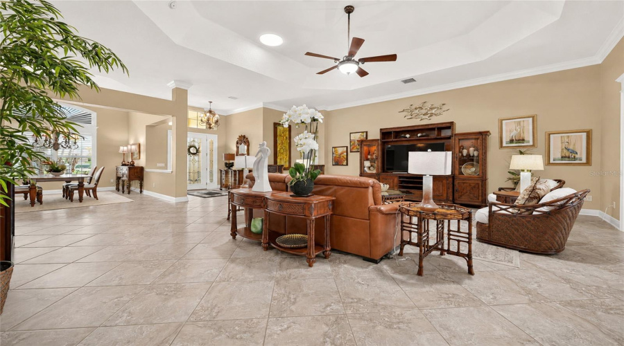 Wide Angle View Of Main Living Area - Living Room (Front), Foyer (Back Center), And Formal Dining Room (Back L)