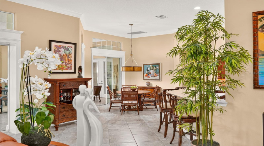 View Of Breakfast Nook From The Back Of The Living Room - Shows Continuation Of 20&Quot; X 20&Quot; Diagonal- Set Tile Flooring, Transom Windows, Cornices &Amp; Woodworking Accenting The Openings Of The Sliding Glass Doors To The Grand Gathering Room.