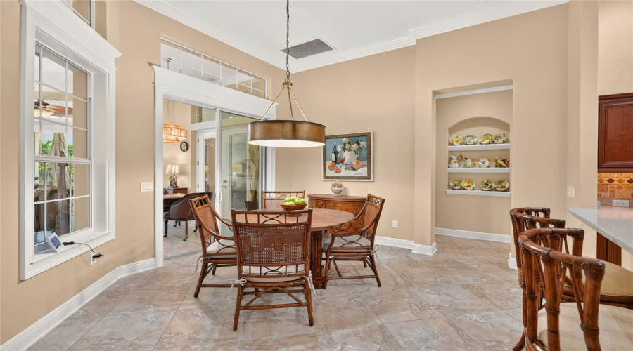 Another View Of Breakfast Nook - Shows Adjacent Raised, Peninsular Breakfast Bar (To R) With Bar Stool Seating For 4 Persons. These 42&Quot; Swivel Counter-Height Stools With Beige Upholstered Seats Are Made Of Rattan &Amp; Bamboo And Named The &Quot;South Beach Swivel Bar Stools&Quot; Of The Island Beach Collection, Manufactured By Tommy Bahama Home.