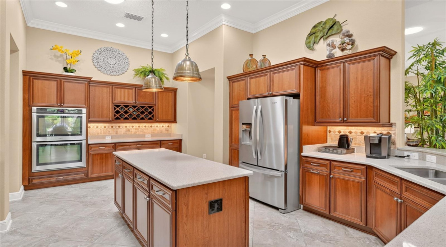 Kitchen - On East Wall, There Is A  Built-In Double Oven, A Wine Rack, Tile Backsplash, And Abundant Cabinet Storage Space. Note Hallway On R Leads To The Guest Wing.