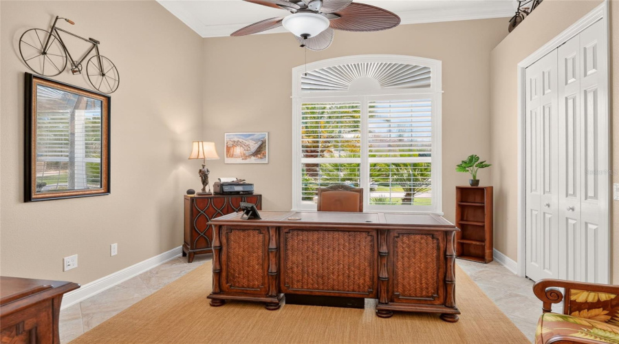 Bedroom #3  - Front Bedroom Was Utilized As An Office. Note Large Window W/ Transom, Plantation Shutters, Closet W/ Bi-Fold Doors (R) With Decorative Plant Shelf Above.