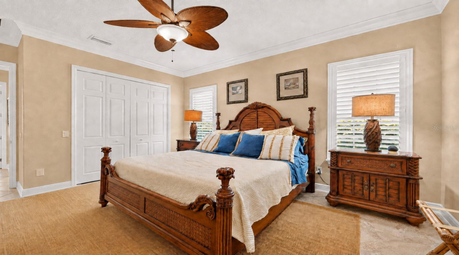 Bedroom #2 - View From Back Corner Of Bedroom Shows Crown Molding, Plantation Shutters, And Ceiling Fan. Note The Carved Tropical Leaf Pineapple Finials On The Bedposts. Per Owner, The Bedroom Set Is Manufactured By Broyhill