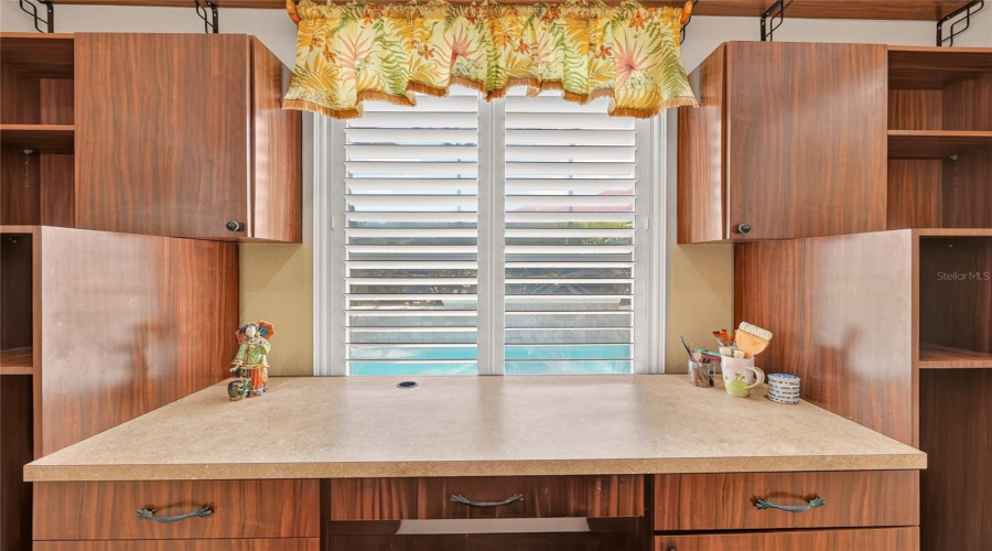 Bedroom #4 - View Shows A Built-In Desk/Workstation W/ Drawers &Amp; Open Shelving. Window W/ Plantation Shutters Allows A Glimpse Of The Pool Area Under A Mansard Screen Enclosure.