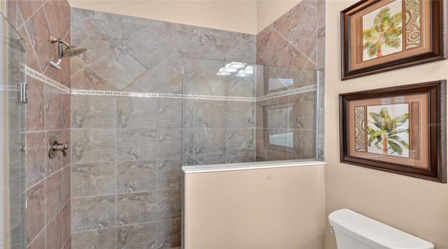 Ensuite Bath (Ba #3) - Tiled Walk-In Shower W/ Decorative Accent Band, Frameless Glass Shower Door, And A Frameless Glass Panel On Half Wall Detail.