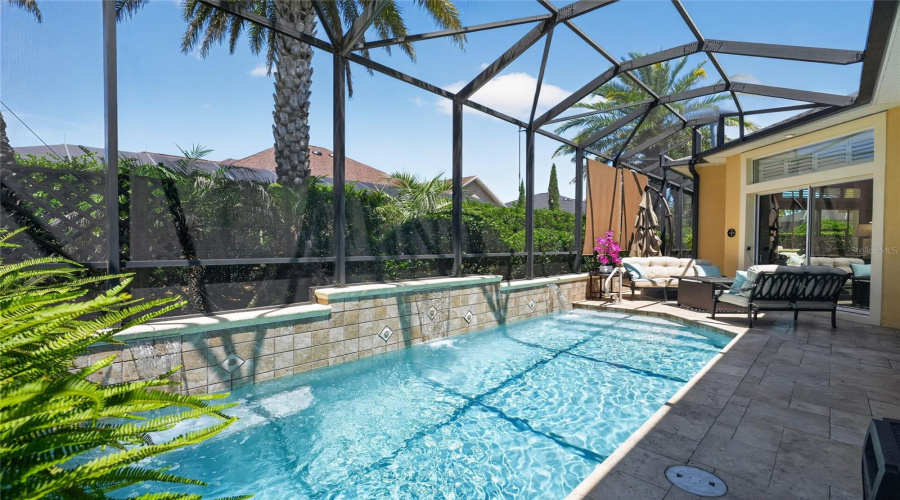 North End Of Pool Area Near Double Sets Of Sliding Glass Doors Leading To The Gathering Room - Shows Travertine Tile Deck And Seating Area With Firepit. Large Mobile &Amp; Expandable Umbrellas Can Be Moved To Either The Pool Side Or The Spa Side For Protection From Harmful Sunlight.