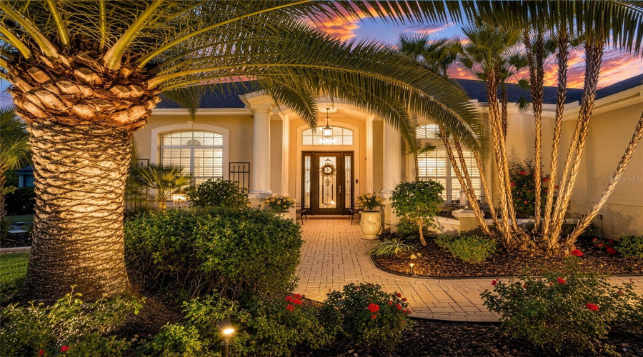 Mature Palms &Amp; Tropical Landscaping W/ Tiered Hardscaping &Amp; Lighting Create A Magical Curb Appeal At Dusk.