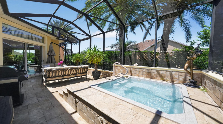 Spa Side Under Mansard Screen Enclosure- Wide Angle View Shows The Travertine Tile Deck, The Custom Built-In Raised Spa W/ Entry Handrail, Another Bronze Statue Of A Woman, And The Firepit &Amp; The Seating Area By The Sliding Glass Doors Leading To The North Side Of Gathering Room.