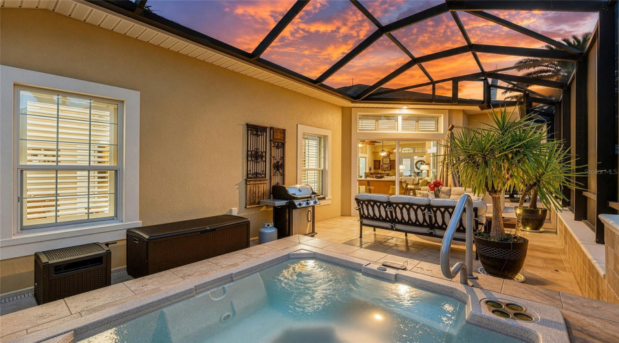 Spa Side Of Mansard Screen Enclosure During Twilight &Amp; Dusk - Shows Watering Hose Storage Container, Pool Equipment Storage Chest, And Barbecue Grill (L Side) Next To Built-In Spa.