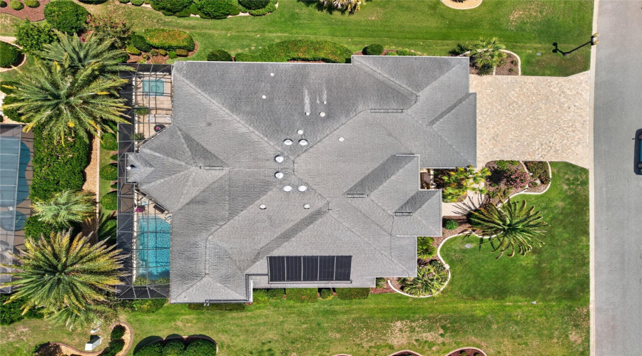 Aerial Overview - Roofline &Amp; Site Context View Showing The Screened Pool Enclosure On West Side Of The Home And The Pavered Driveway Approach On The East Side. Note 5 Solar Panels (On South Side Of Home) Which The Heat The Freshwater Swimming Pool.