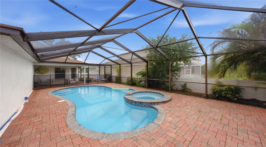 Screened And Pavered Freeform Pool