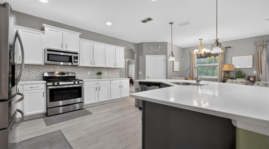 Stunning Kitchen Featuring Tons Of Cabinetry, Custom Tile Backsplash, Stainless Steel Appliances And Quartz Countertops!!