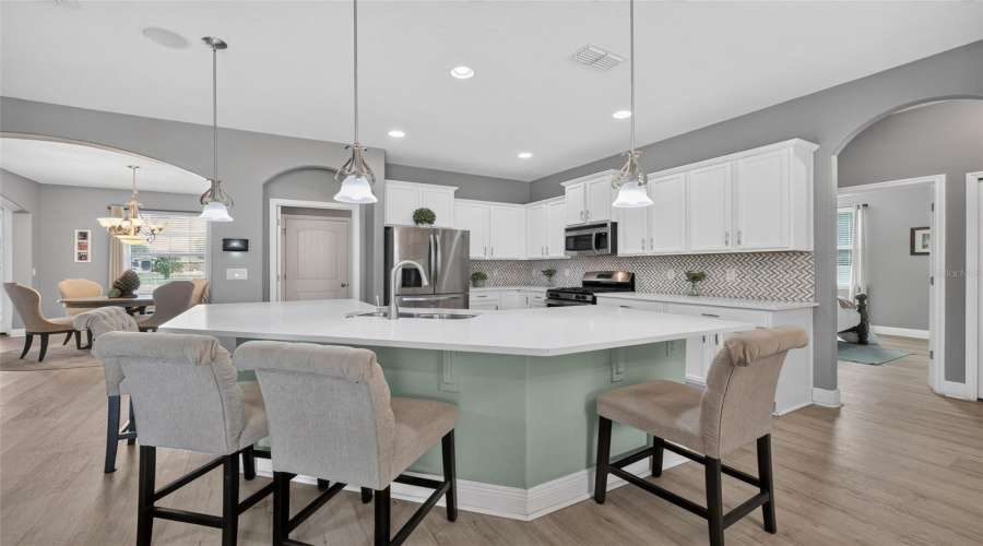 Breakfast Bar Overlooking This Beautifully Updated Kitchen With Quartz Countertops