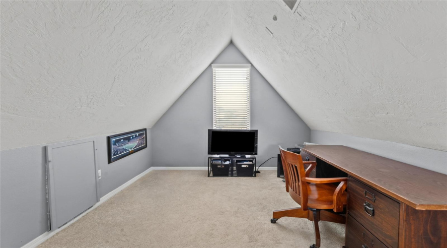 The Spiral Staircase Off The Living Room Leads Up To A Little Loft Space.