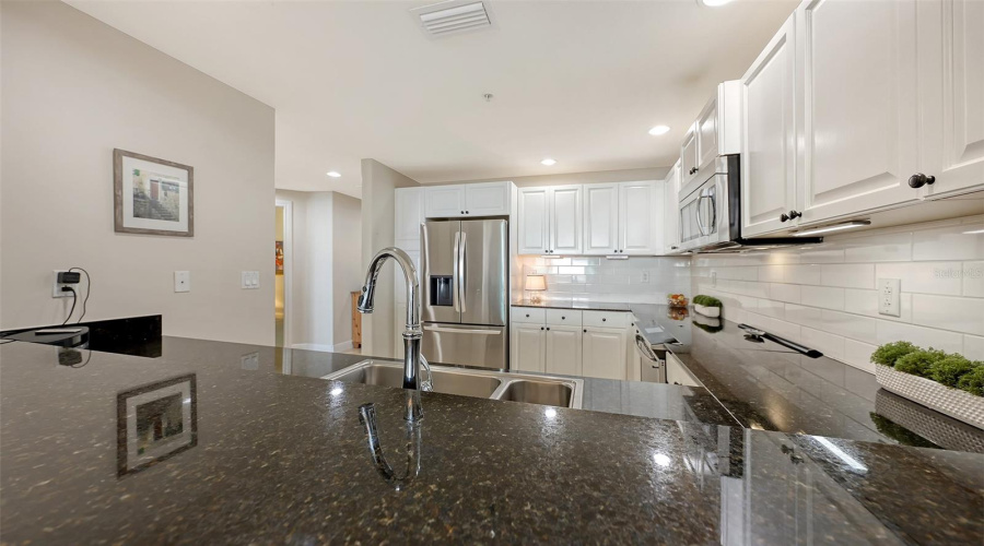 Black Granite Counterswhite Tile Backsplash