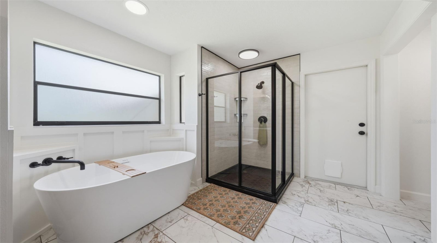 Custom Shower With Sliding Entry Doors And Gorgeous Soaking Tub