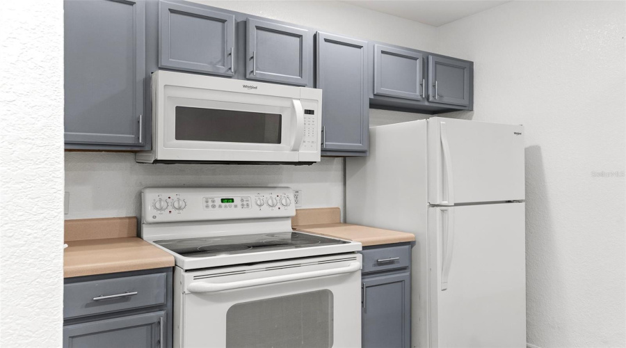 Close Up Of Stove, Microwave, And Refrigerator