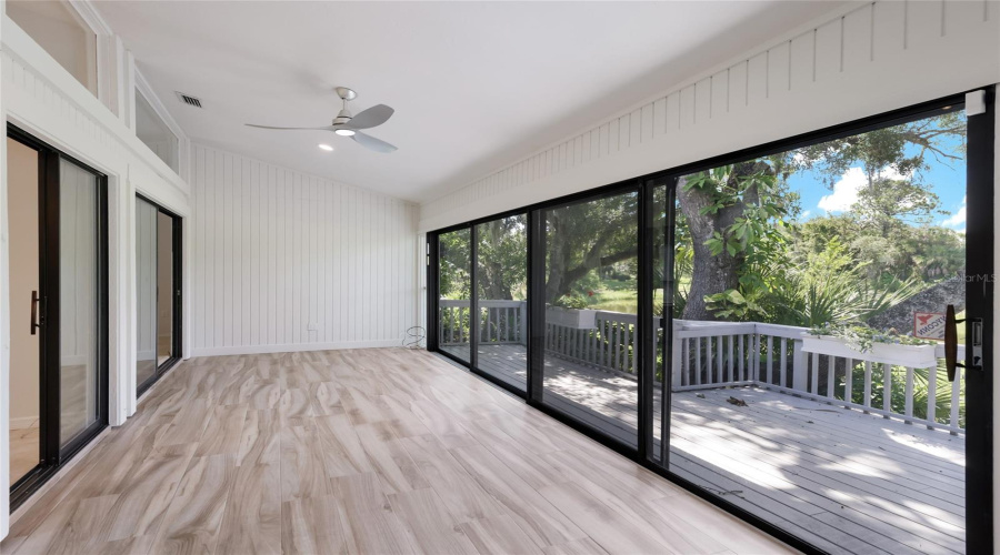 Four Season Lanai With Updated Flooring And Newer Sliding Glass Doors.