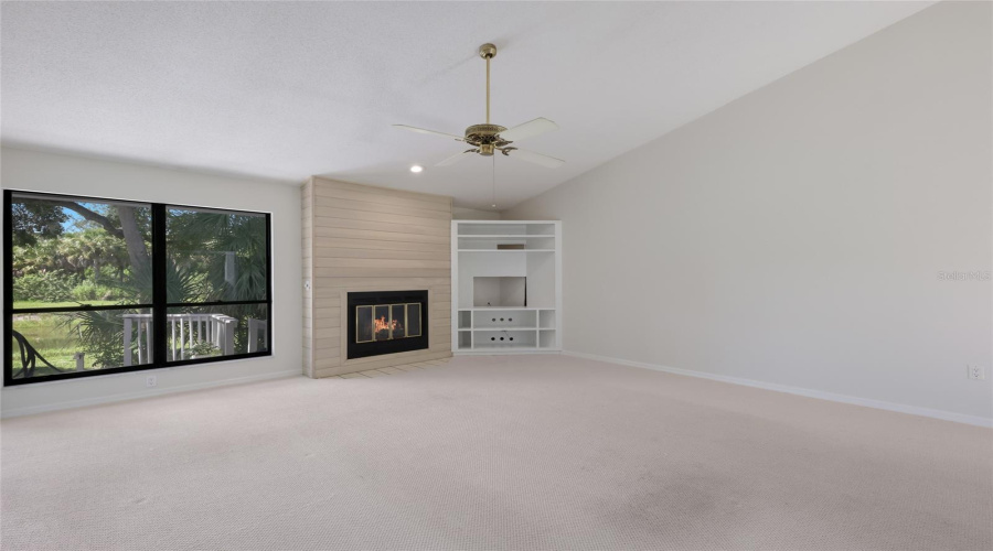 Freshly Painted Living Room With Wood Burning Fireplace.