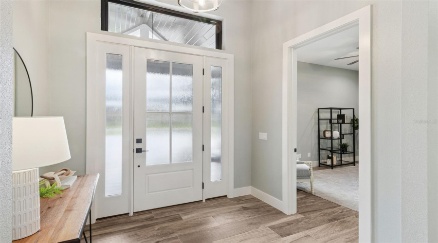 Elegant Front Entry With Double Glass Doors And Dedicated Home Office