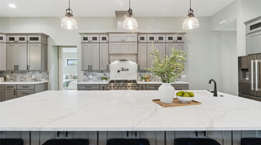 Quartz Island With Seating And Designer Lighting