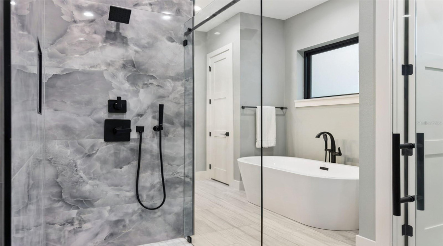Designer Shower With Luxury Tile And Rainfall Fixtures