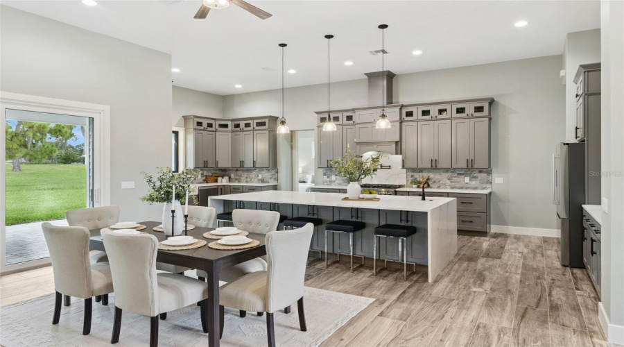 Expansive Kitchen With Custom Cabinetry And Oversized Island