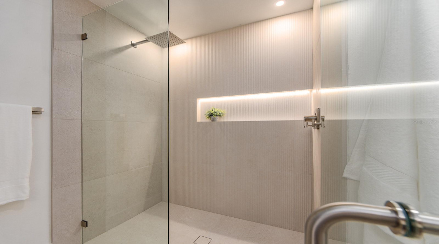 Second Bath Features A Fabulous  Walk In Shower With Frameless Enclosure And Lighted Niche