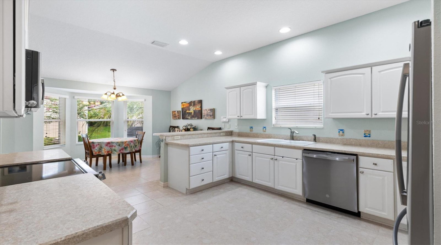 Spacious Kitchen With Light Cabinets And Abundant Counterspace.